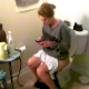 A girl that appears to be drunk is video-recorded taking a shit while sitting on a toilet. A plop is barely audible, but she wipes and shows us the dirty toilet paper.